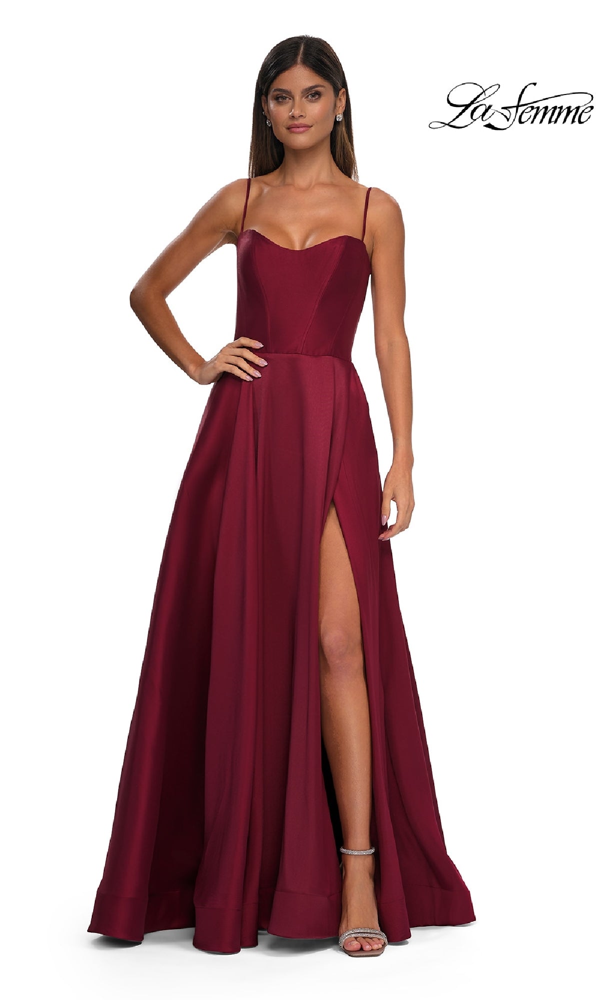 A woman models the Sheer-Corset Long A-Line Prom Gown, La Femme 32670—a sleeveless, floor-length stretch Mikado dress with spaghetti straps and a thigh-high slit—against a white background; the La Femme logo appears in the top right corner.